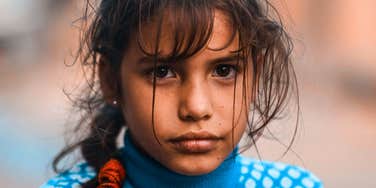 withdrawn sad young girl being raised by dysregulated parents