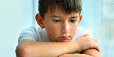 upset little boy after parents were inconsiderate of his emotions