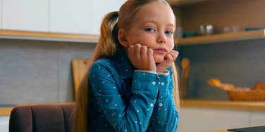 sad young girl being raised by insecure parents