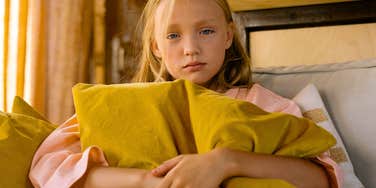 sad anxious young girl raised by an unkind mother