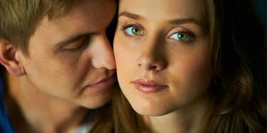 serious woman in a new relationship looking distant from man