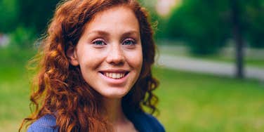 highly intelligent redheaded woman smiling