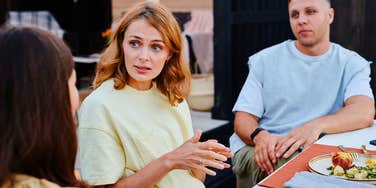 woman being undermined by her family at a dinner