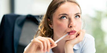 woman rolling her eyes at annoying phrases in a job description 