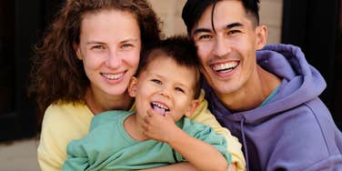 happy family mom dad and son smiling