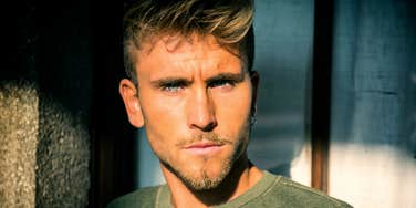 Man with intense, guarded stare, reflecting emotional walls in relationships