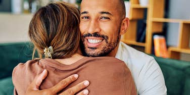 Man's genuine, beaming smile while embracing her says more than any "just being nice" ever could.