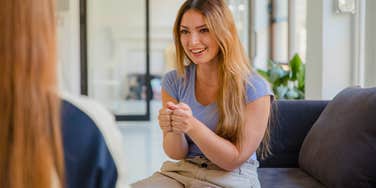 woman smiling at colleague trying to get a compliment