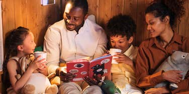 parents buying books and reading them to their kids at night