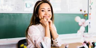 Smiling at her desk in front of the chalkboard, this teacher is easy to picture as someone worth getting to know.