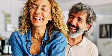 A couple laughing this freely together speaks to a relationship built on real comfort.