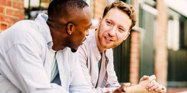 Two men lean in for a genuine conversation, the kind of honesty integrity actually sounds like.