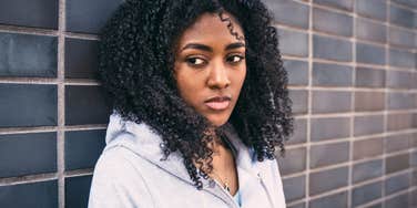 woman who looks emotionally shut-down giving side-eye 