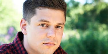 Man who didn't have a stable childhood looking thoughtfully at camera