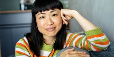 Woman with high vibe smiling warmly at the camera