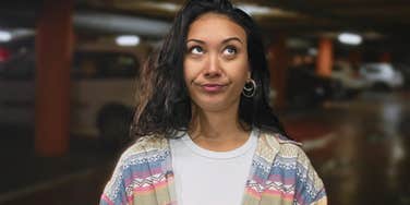 Young woman with low vibes rolling her eyes 