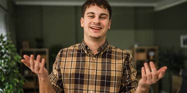 Lazy young man shrugging off his slacker behaviors