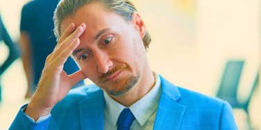 man at his job regretting saying yes to more work