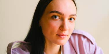 gentle empathetic woman smiling slightly
