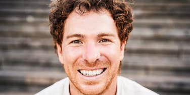 millennial man laughing at iconic phrases from his generation 