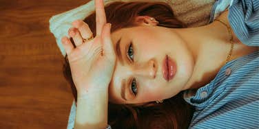 sad woman with low emotional energy laying down