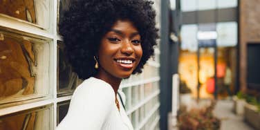 happy smiling unforgettable woman standing outside