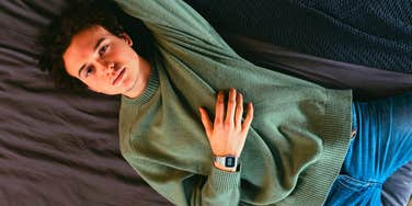 unmotivated lazy man laying in bed thinking