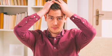 frustrated man exhausted by hard work sitting in office