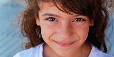 happy little girl being raised by caring parents