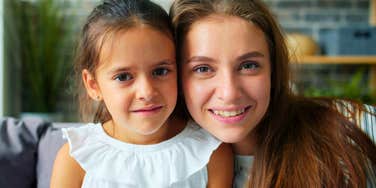 gen Z mom smiling next to her daughter