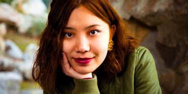 pensive woman appearing needy with chin on her hand