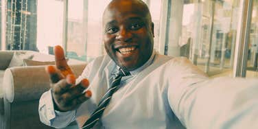 smiling man finding meaning at his job feeling happy
