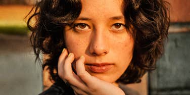 Woman's steady, unflinching stare signals someone finished softening her words for anyone.