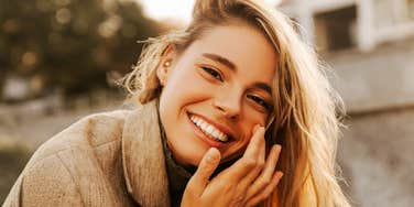 Her wide, radiant smile is the look of someone who's done playing small.