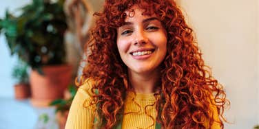 empathetic woman with red hair smiling 