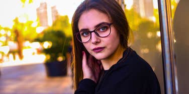 high-IQ woman feeling down on herself looking serious