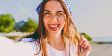 unbothered woman taking a silly selfie