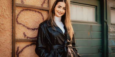 fashionable millennial woman dressed up standing outside