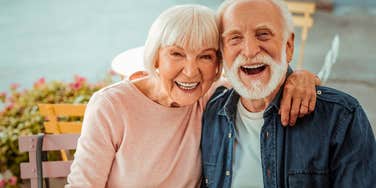 older boomer couple smiling enjoying their good marriage