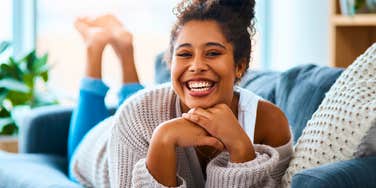 happy millennial woman relaxing at home on her day off