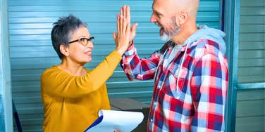 gen x man doing a favor for a boomer woman