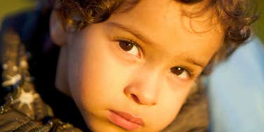 sad young child whose parents never comforted him