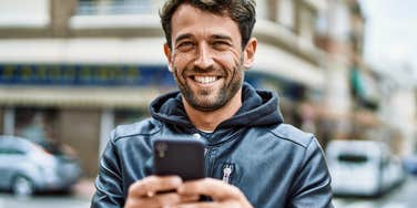 man who is highly respected smiling on a downtown street 