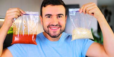 man holding up washed and reused ziploc bags