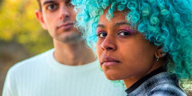 sad woman standing in front of her toxic partner