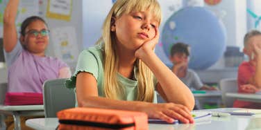 young girl in class struggling to learn