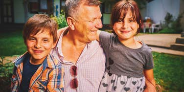 happy grandkids sitting with their grandfather making memories