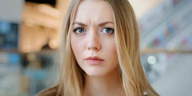 woman with a negative look on her face scowling slightly 