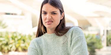 Woman looks annoyed by someone else's problems