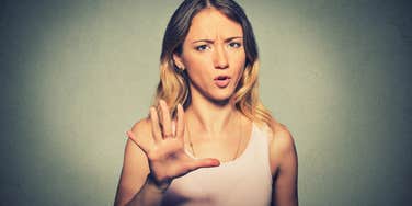 woman with zero filter puts her hand up rudely 